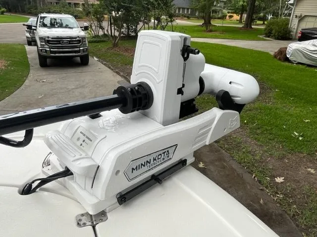 Slide: The Image of Minn Kota trolling motor on 2014 Sportsman Heritage 231 Center Console boat, parked in driveway. - 11