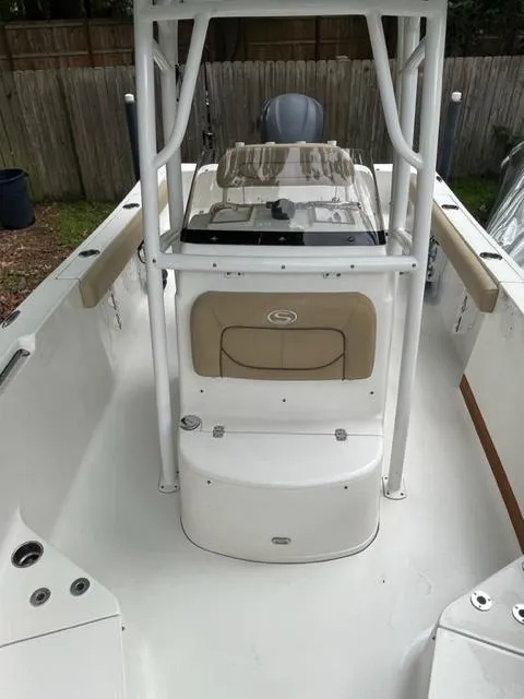 Slide: The Image of 2014 Sportsman Heritage 231 Center Console boat interior with seating and console. - 13