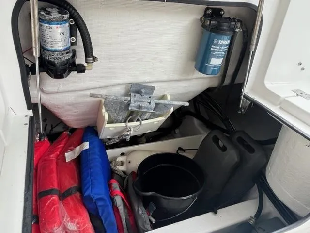 Slide: The Image of Storage compartment of 2014 Sportsman Heritage 231 Center Console with life jackets and equipment. - 15