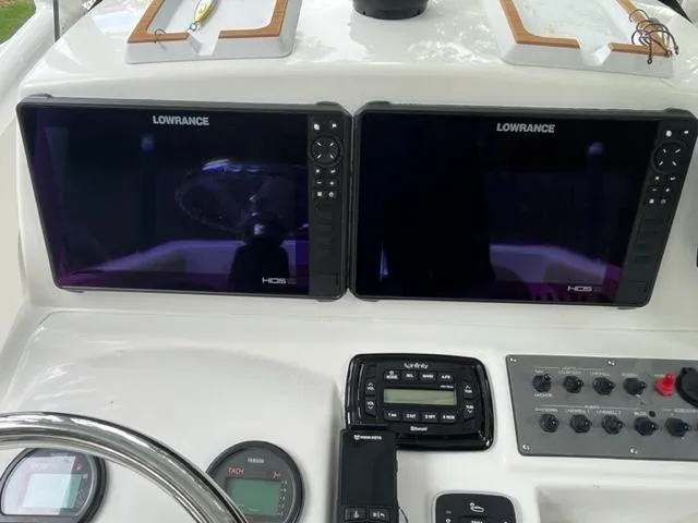 Slide: The Image of Dashboard of 2014 Sportsman Heritage 231 Center Console with Lowrance displays and controls. - 16