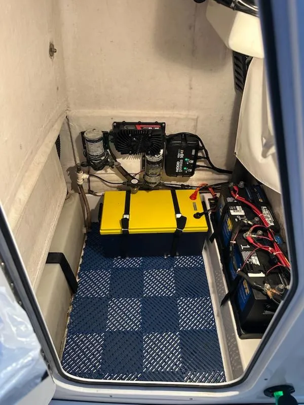 Slide: The Image of 2014 Sportsman Heritage 231 Center Console battery compartment with equipment and wiring. - 18