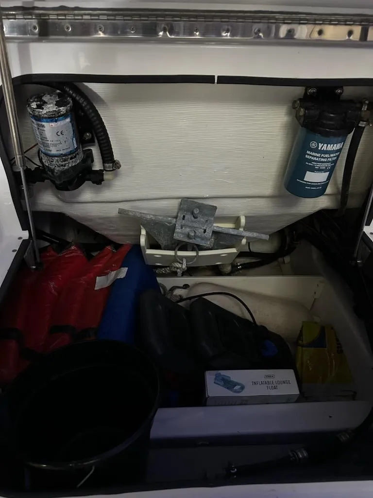 Slide: The Image of Storage compartment of 2014 Sportsman Heritage 231 Center Console with marine equipment and supplies. - 19