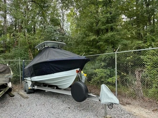 Slide: The Image of 2014 Sportsman Heritage 231 Center Console boat covered and parked on a trailer. - 2