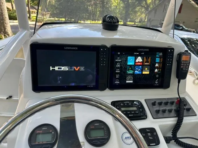 Slide: The Image of Center console of 2014 Sportsman Heritage 231 with dual Lowrance displays and marine controls. - 3