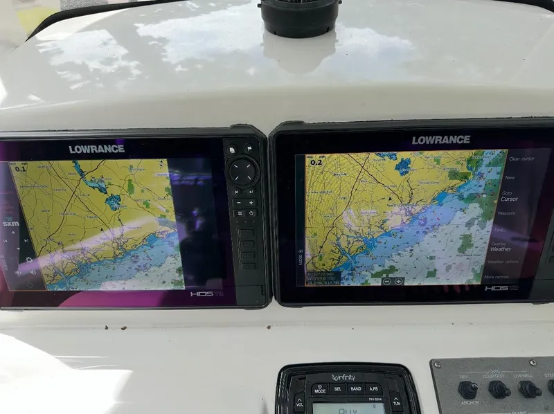 Slide: The Image of Dual Lowrance navigation screens on 2014 Sportsman Heritage 231 Center Console boat. - 4