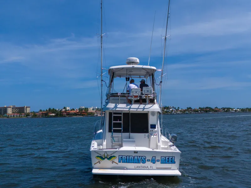 Slide: The Image of 2001 Mediterranean 38 Convertible boat on water, labeled "Fridays-4-Reel," Lantana, FL. - 1