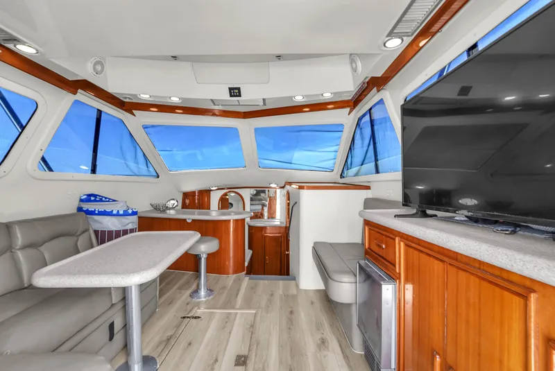 Slide: The Image of Interior of 2001 Mediterranean 38 Convertible yacht with modern furnishings and large windows. - 10