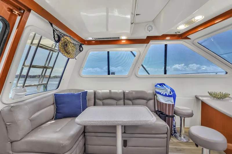 Slide: The Image of Luxurious interior of 2001 Mediterranean 38 Convertible yacht with plush seating and ocean view. - 13