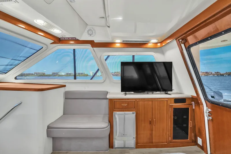 Slide: The Image of Interior of 2001 Mediterranean 38 Convertible yacht with seating, TV, and ocean view. - 14
