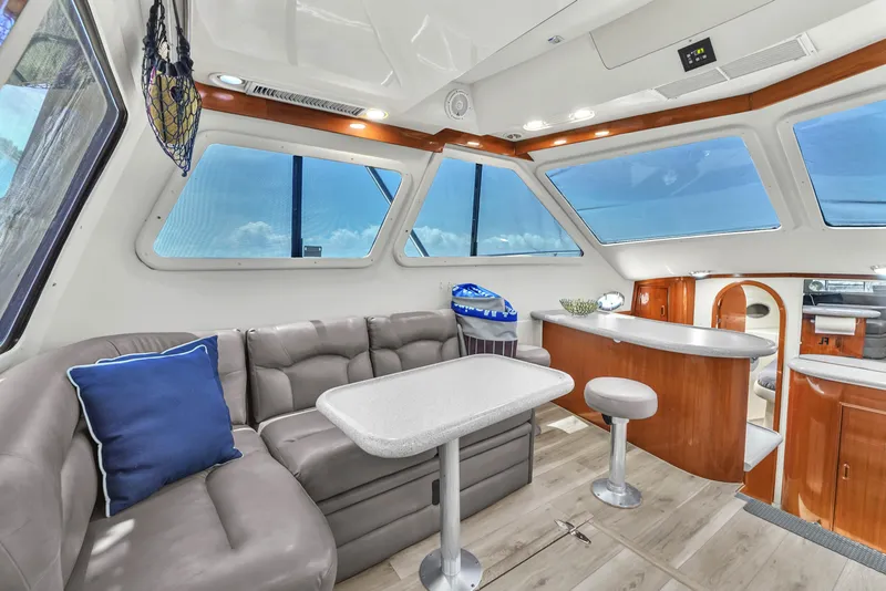 Slide: The Image of Luxurious interior of a 2001 Mediterranean 38 Convertible yacht with modern seating and panoramic windows. - 15