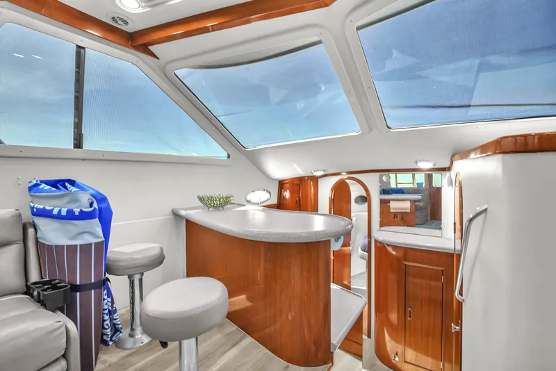 Slide: The Image of Interior of 2001 Mediterranean 38 Convertible yacht with modern seating and large windows. - 16