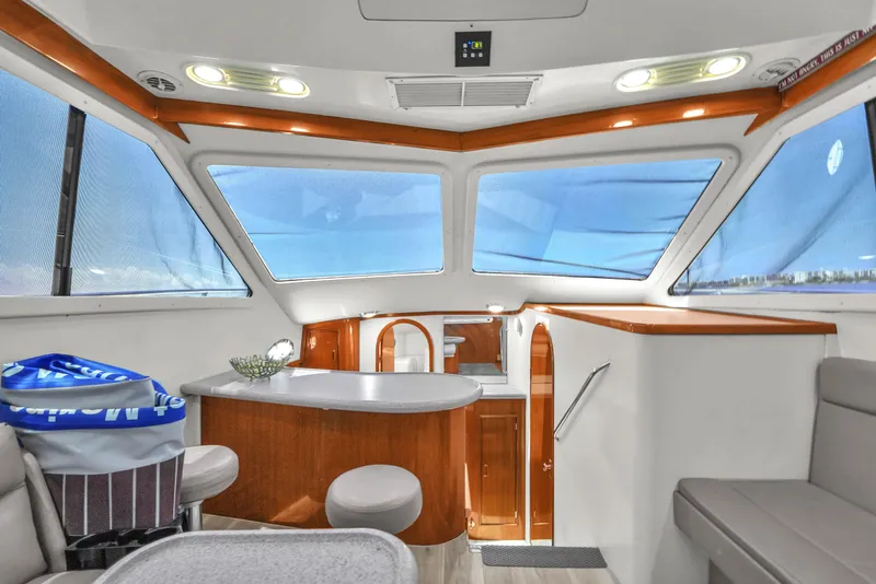 Slide: The Image of Interior of 2001 Mediterranean 38 Convertible yacht with modern seating and panoramic windows. - 17