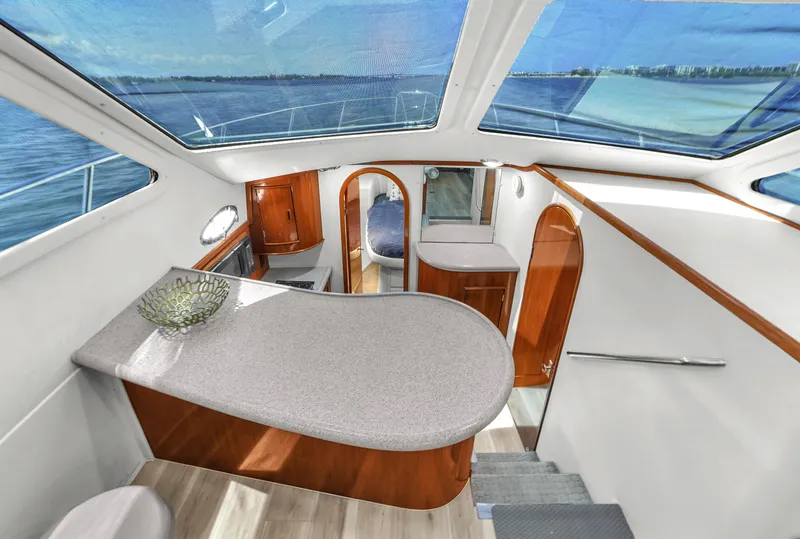Slide: The Image of Interior of 2001 Mediterranean 38 Convertible yacht with modern design and panoramic windows. - 18