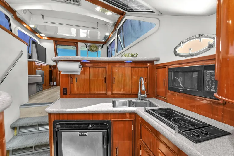 Slide: The Image of Interior of 2001 Mediterranean 38 Convertible yacht with modern kitchen amenities. - 21