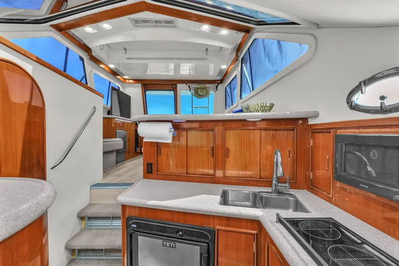 Slide: The Image of Interior of 2001 Mediterranean 38 Convertible yacht with modern kitchen and seating area. - 22