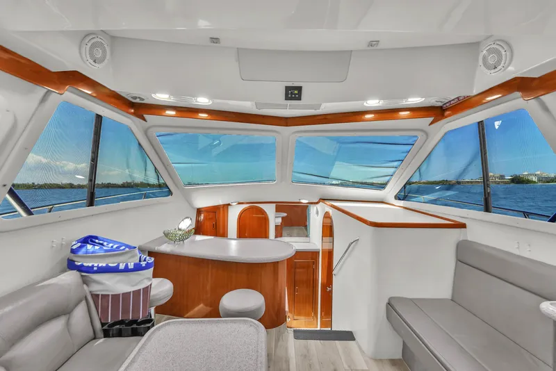 Slide: The Image of Interior of 2001 Mediterranean 38 Convertible yacht with panoramic windows and modern seating. - 23