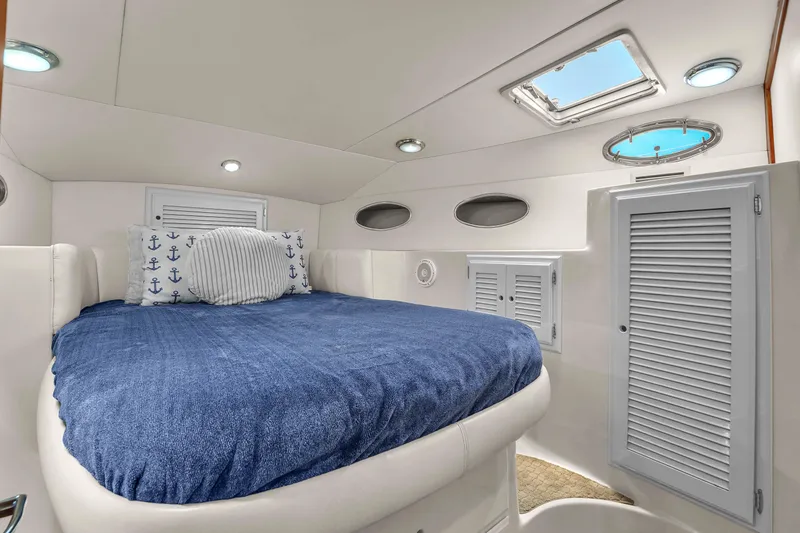 Slide: The Image of Luxurious cabin interior of 2001 Mediterranean 38 Convertible yacht with blue bedding. - 25