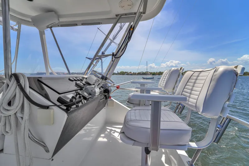 Slide: The Image of 2001 Mediterranean 38 Convertible yacht cockpit with white seating and ocean view. - 30