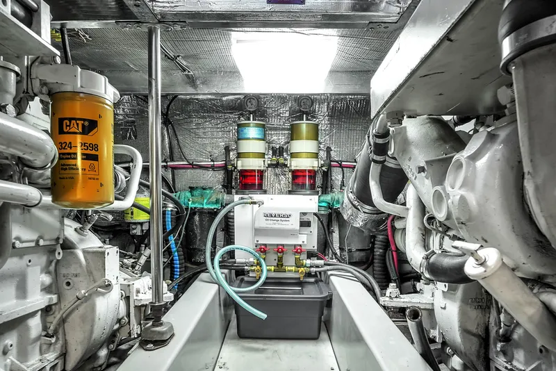 Slide: The Image of Engine room of 2001 Mediterranean 38 Convertible yacht, featuring CAT machinery and complex piping. - 34