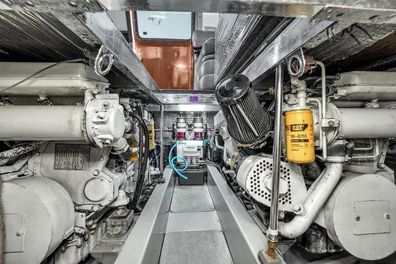 Slide: The Image of Engine room of 2001 Mediterranean 38 Convertible yacht, showcasing dual engines and mechanical components. - 36