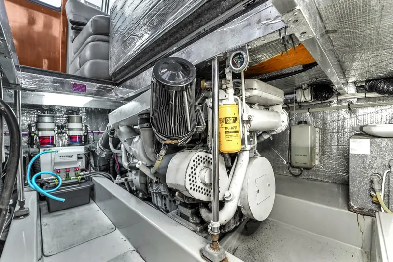 Slide: The Image of Engine room of a 2001 Mediterranean 38 Convertible boat, showcasing machinery and components. - 38