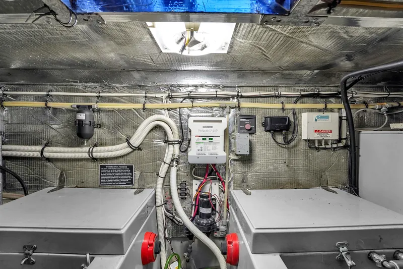 Slide: The Image of Engine room of a 2001 Mediterranean 38 Convertible boat, showcasing electrical systems and components. - 39