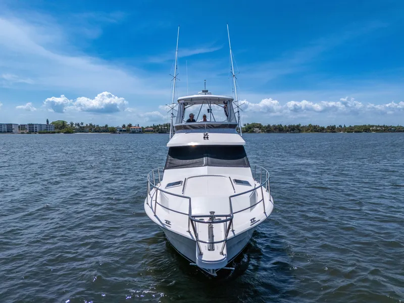 Slide: The Image of 2001 Mediterranean 38 Convertible yacht on open water under clear blue sky. - 42