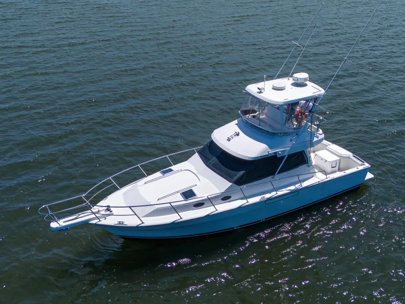 Slide: The Image of 2001 Mediterranean 38 Convertible yacht cruising on open water. - 44