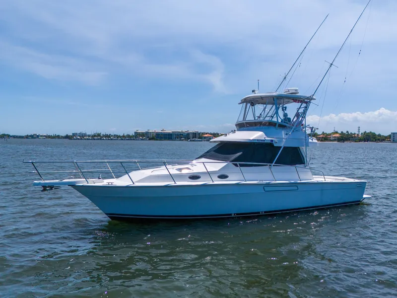 Slide: The Image of 2001 Mediterranean 38 Convertible yacht on calm water, clear sky background. - 45
