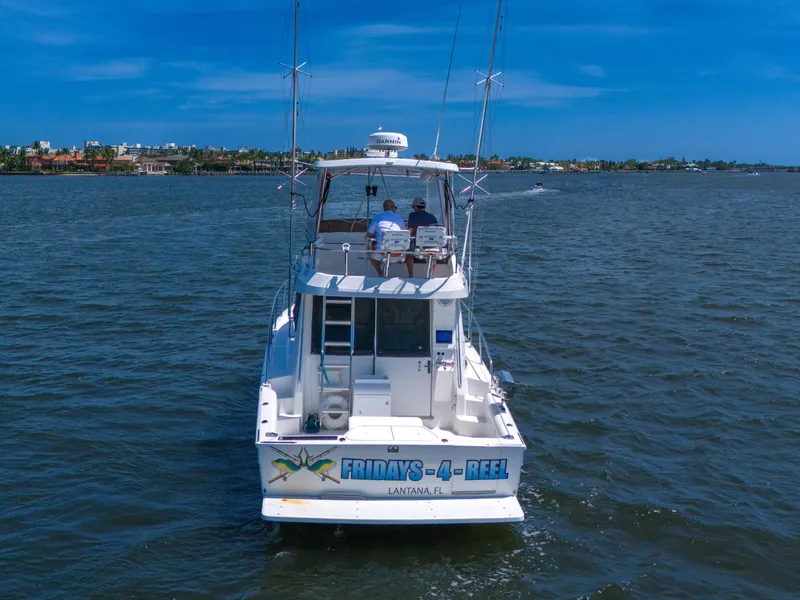Slide: The Image of 2001 Mediterranean 38 Convertible boat on open water, clear sky, rear view. - 48