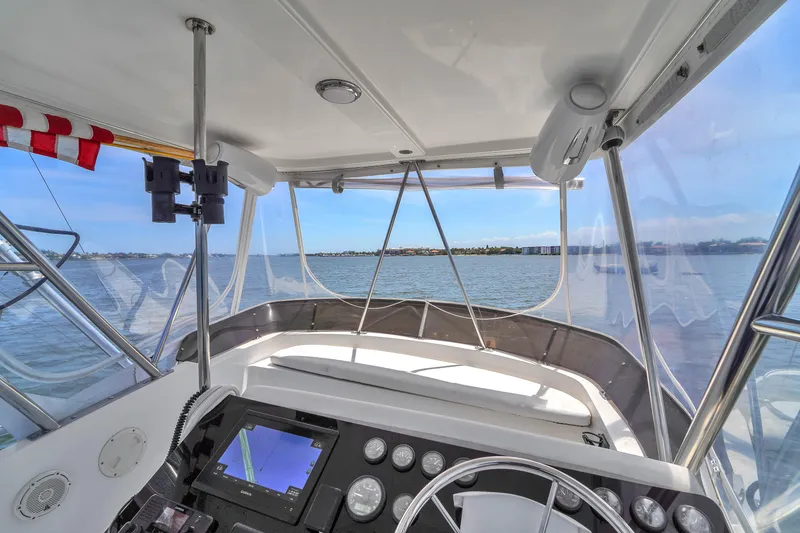 Slide: The Image of Cockpit view of 2001 Mediterranean 38 Convertible yacht on open water. - 7