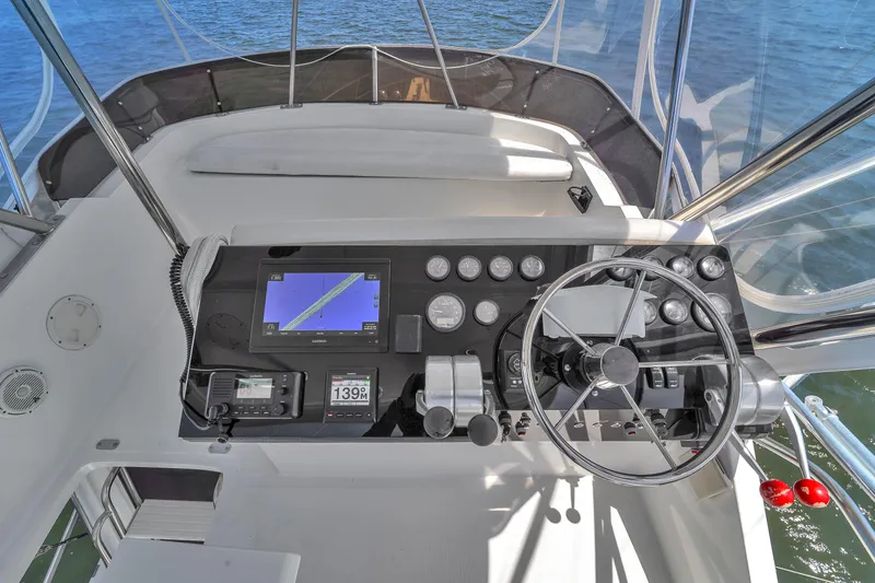 Slide: The Image of Cockpit of 2001 Mediterranean 38 Convertible yacht with navigation controls and steering wheel. - 8