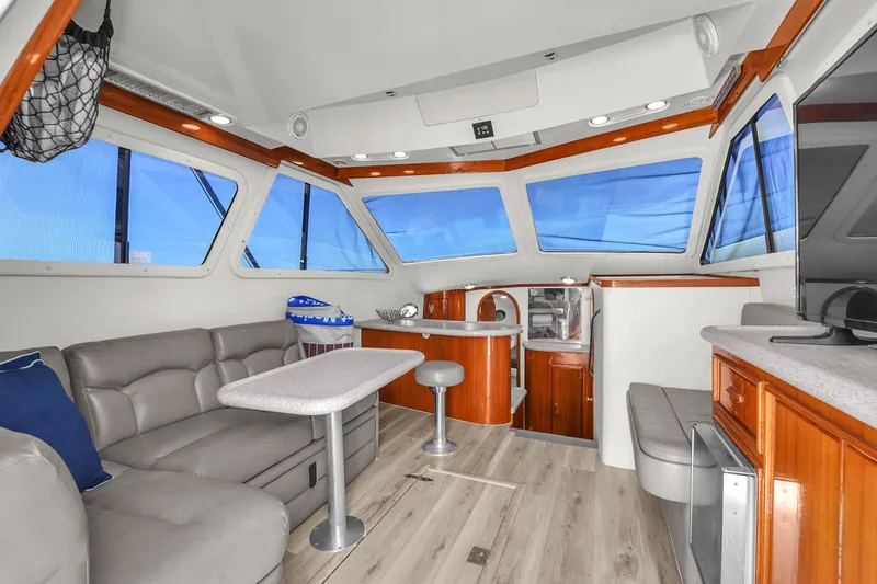 Slide: The Image of Interior of 2001 Mediterranean 38 Convertible yacht with modern seating and panoramic windows. - 9