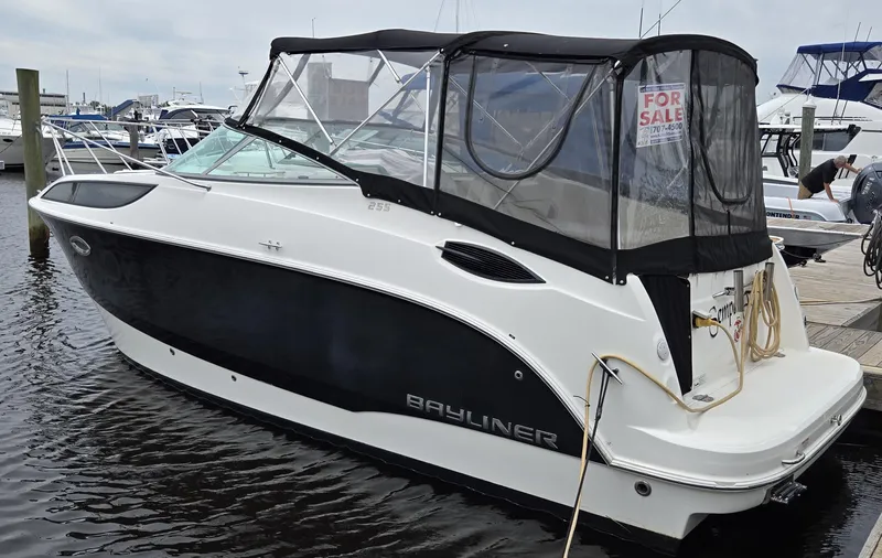 The Image of 2012 Bayliner 255 Cruiser boat docked, black and white, with "For Sale" sign. - 0