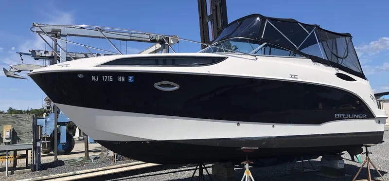 Slide: The Image of 2012 Bayliner 255 Cruiser boat on display at a marina. - 12