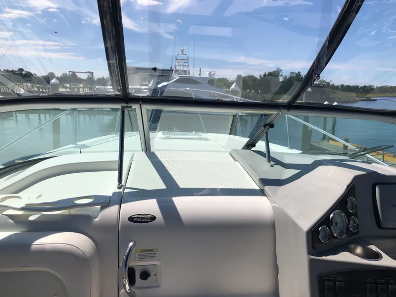 Slide: The Image of 2012 Bayliner 255 Cruiser cockpit view with clear windshield and dashboard controls. - 17