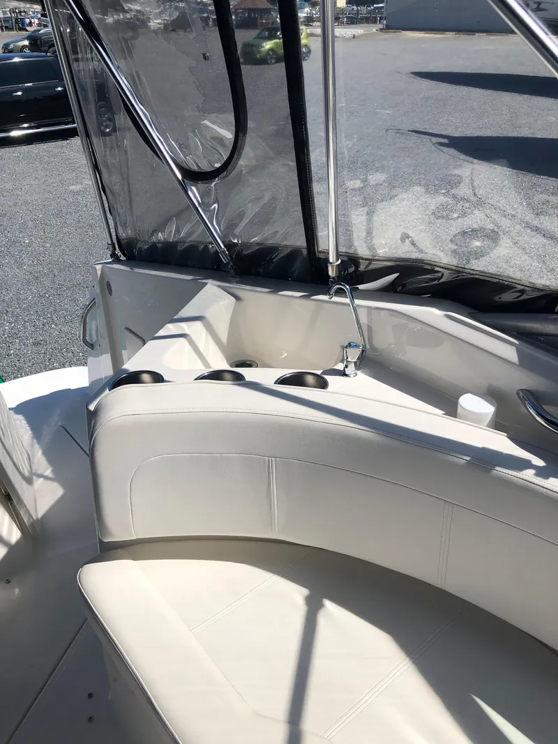 Slide: The Image of 2012 Bayliner 255 Cruiser interior with white seating and cup holders. - 18