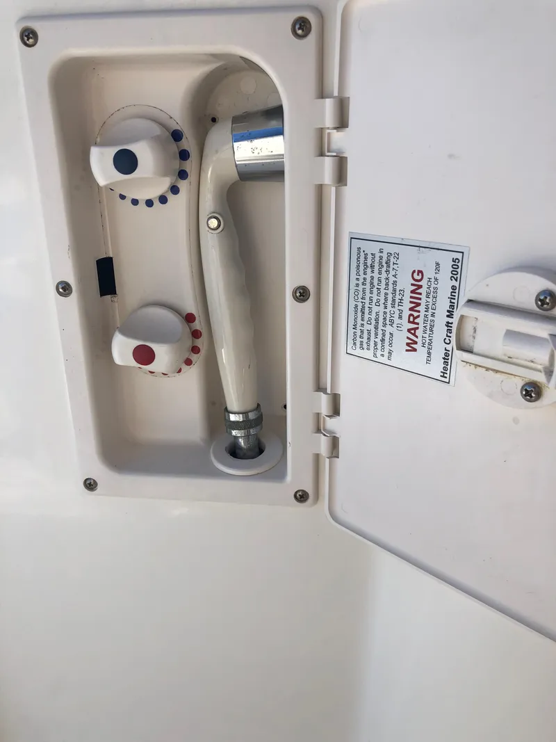 Slide: The Image of 2012 Bayliner 255 Cruiser shower controls with warning label. - 19