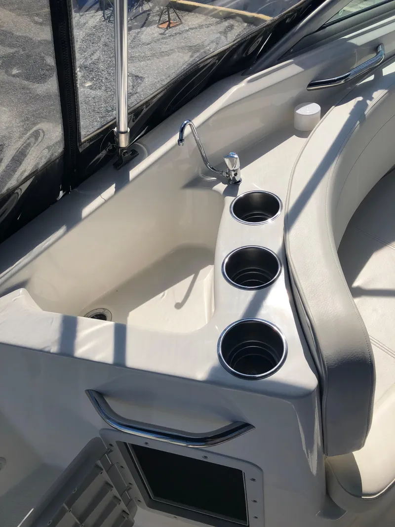 Slide: The Image of 2012 Bayliner 255 Cruiser interior with sink and cup holders. - 20