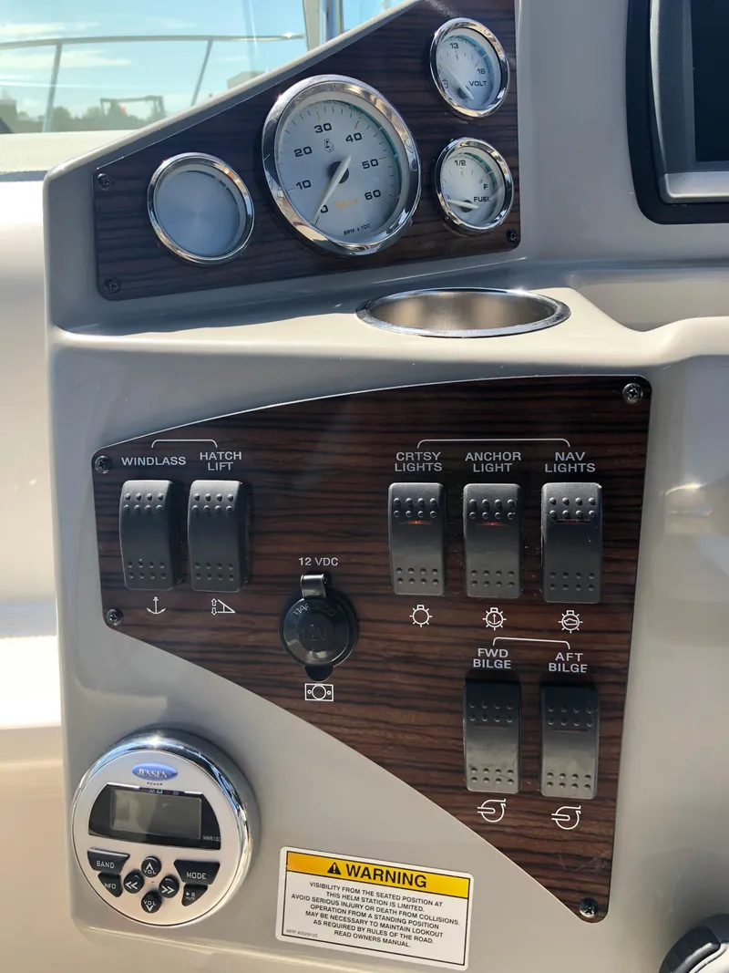 Slide: The Image of Control panel of a 2012 Bayliner 255 Cruiser with gauges and switches. - 24
