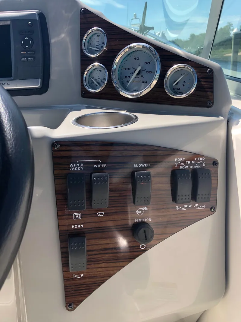 Slide: The Image of Dashboard of a 2012 Bayliner 255 Cruiser with gauges and control switches. - 25