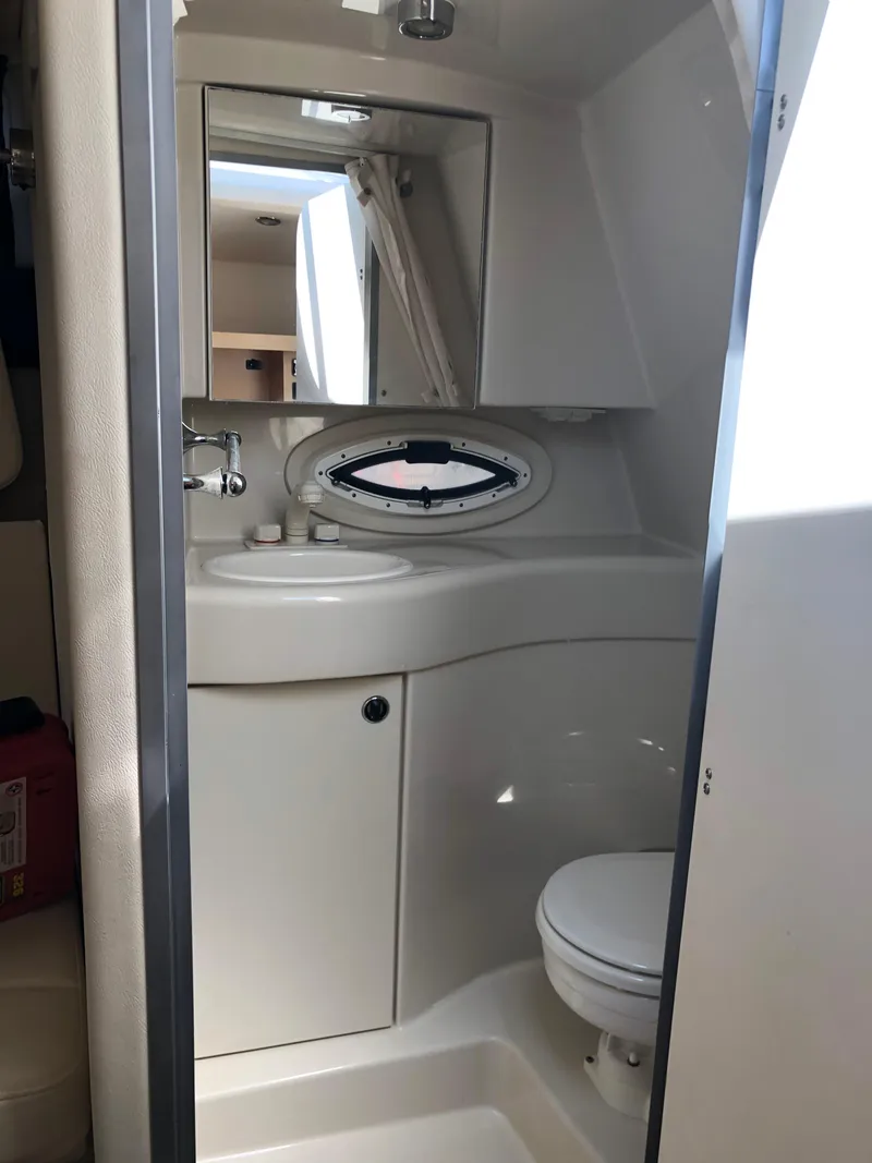 Slide: The Image of 2012 Bayliner 255 Cruiser bathroom interior with sink, mirror, and toilet. - 34