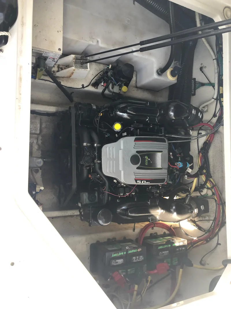 Slide: The Image of Engine compartment of a 2012 Bayliner 255 Cruiser boat, showcasing the engine and wiring. - 38