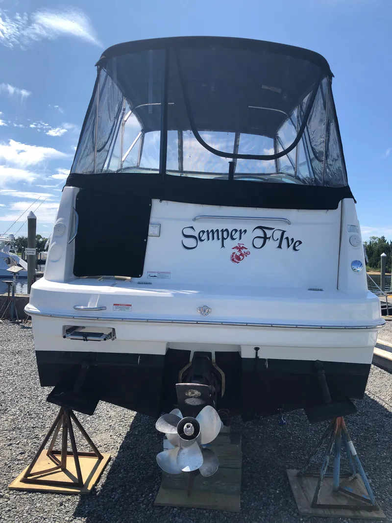 Slide: The Image of 2012 Bayliner 255 Cruiser boat on stands, rear view, with "Semper Five" text. - 39