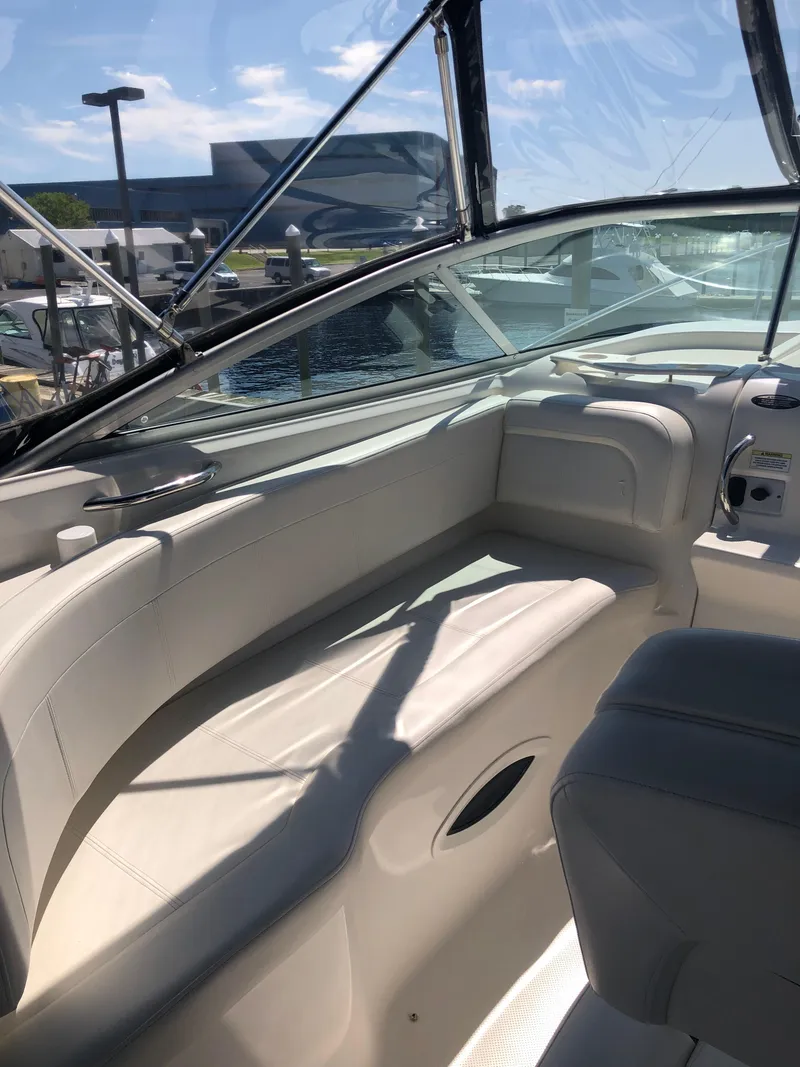 Slide: The Image of 2012 Bayliner 255 Cruiser interior with seating and clear canopy under sunny skies. - 41