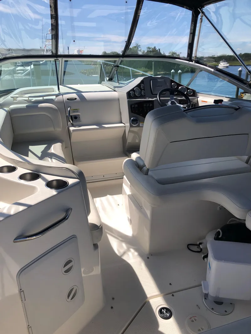 Slide: The Image of 2012 Bayliner 255 Cruiser interior with helm, seating, and dashboard. - 5