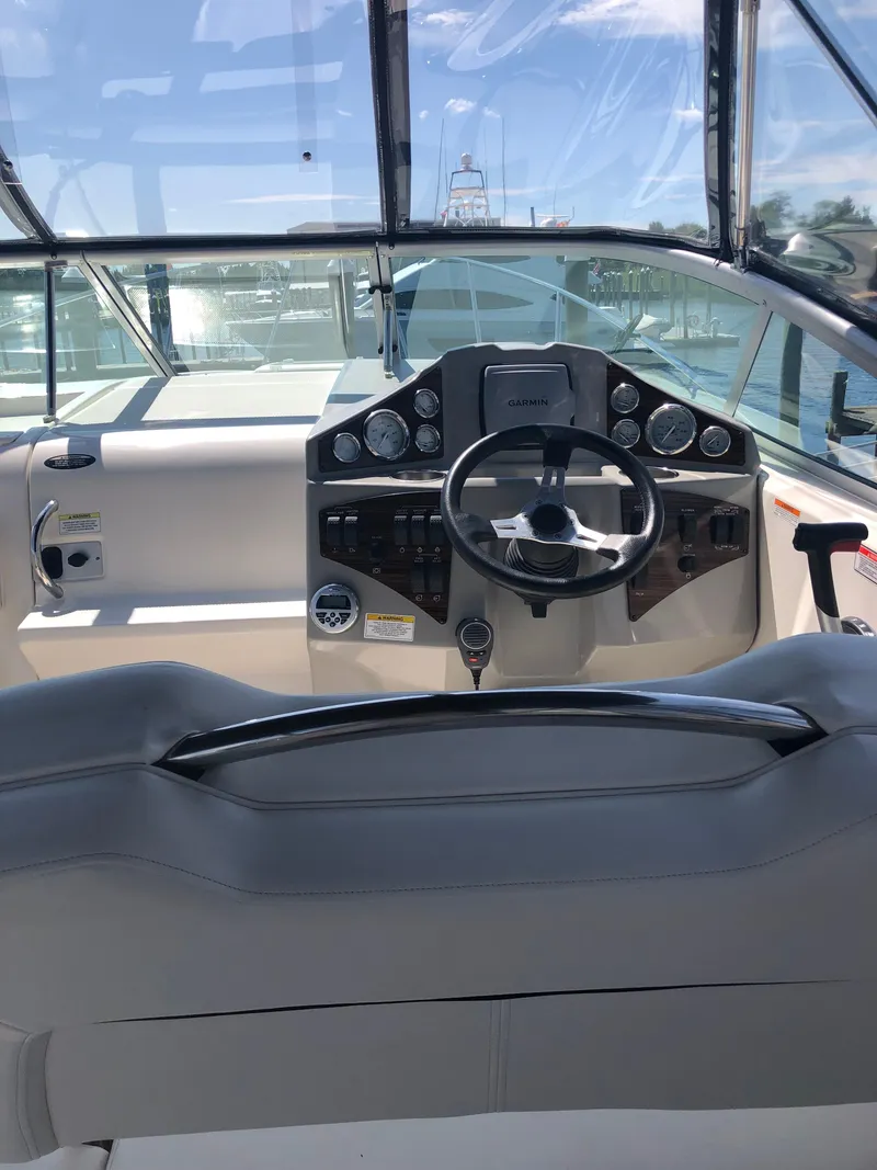 Slide: The Image of 2012 Bayliner 255 Cruiser helm with steering wheel and instrument panel. - 8