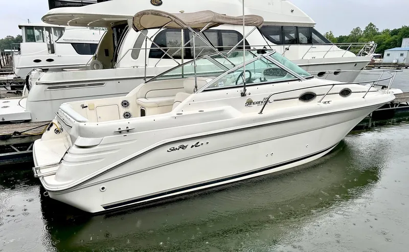 The Image of 1999 Sea Ray 270 Sundancer boat docked at marina, side view. - 0