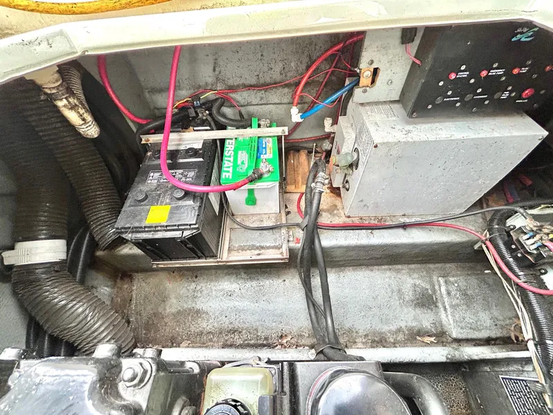 Slide: The Image of Engine compartment of a 1999 Sea Ray 270 Sundancer with visible battery and wiring. - 18