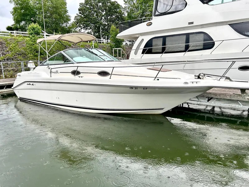 Slide: The Image of 1999 Sea Ray 270 Sundancer boat docked on a rainy day. - 3
